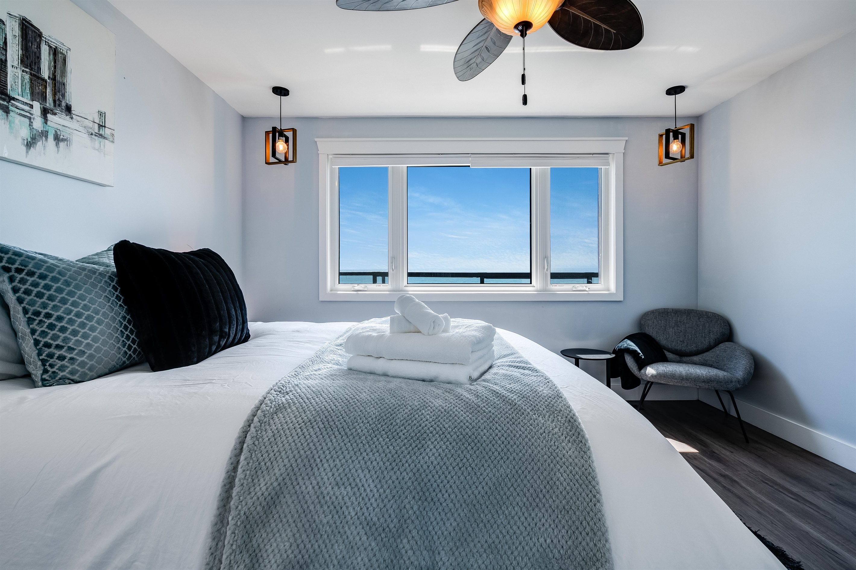 Queen Bedroom Sculptural lighting above a low-profile bed