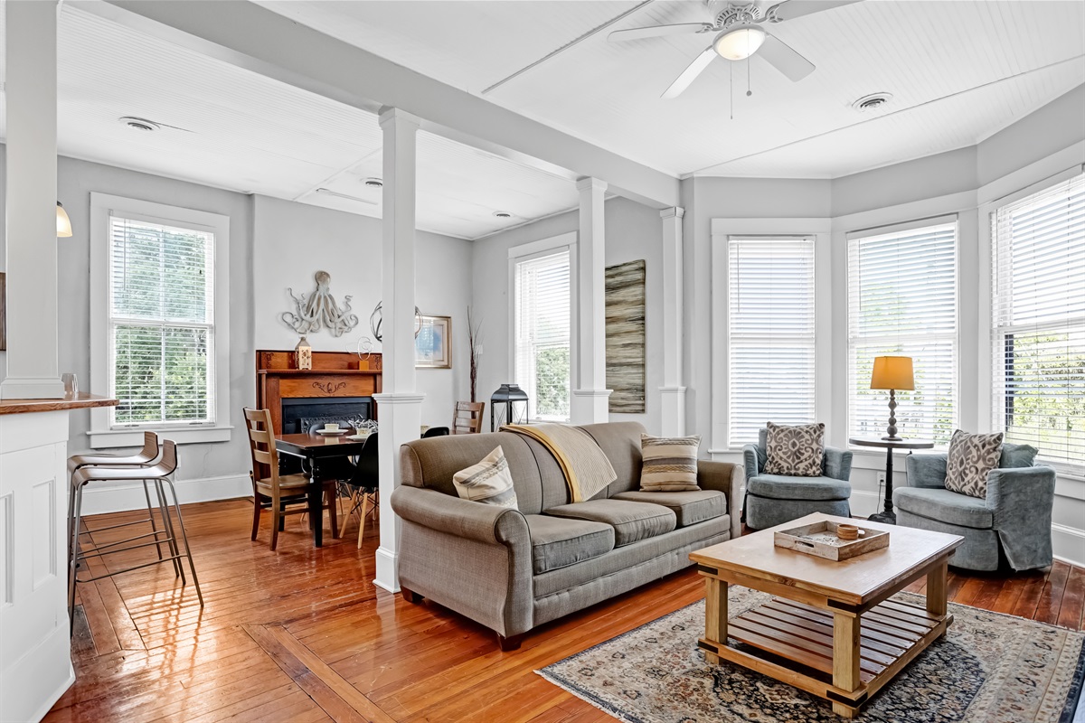 Soaring ceilings and a sunlit bay window make this living room the perfect place to relax.
