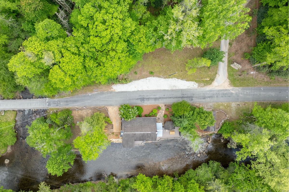 This aerial view showcases the full property, including the scenic junction where Little Snowbird Creek meets Snowbird Creek beside the cabin.