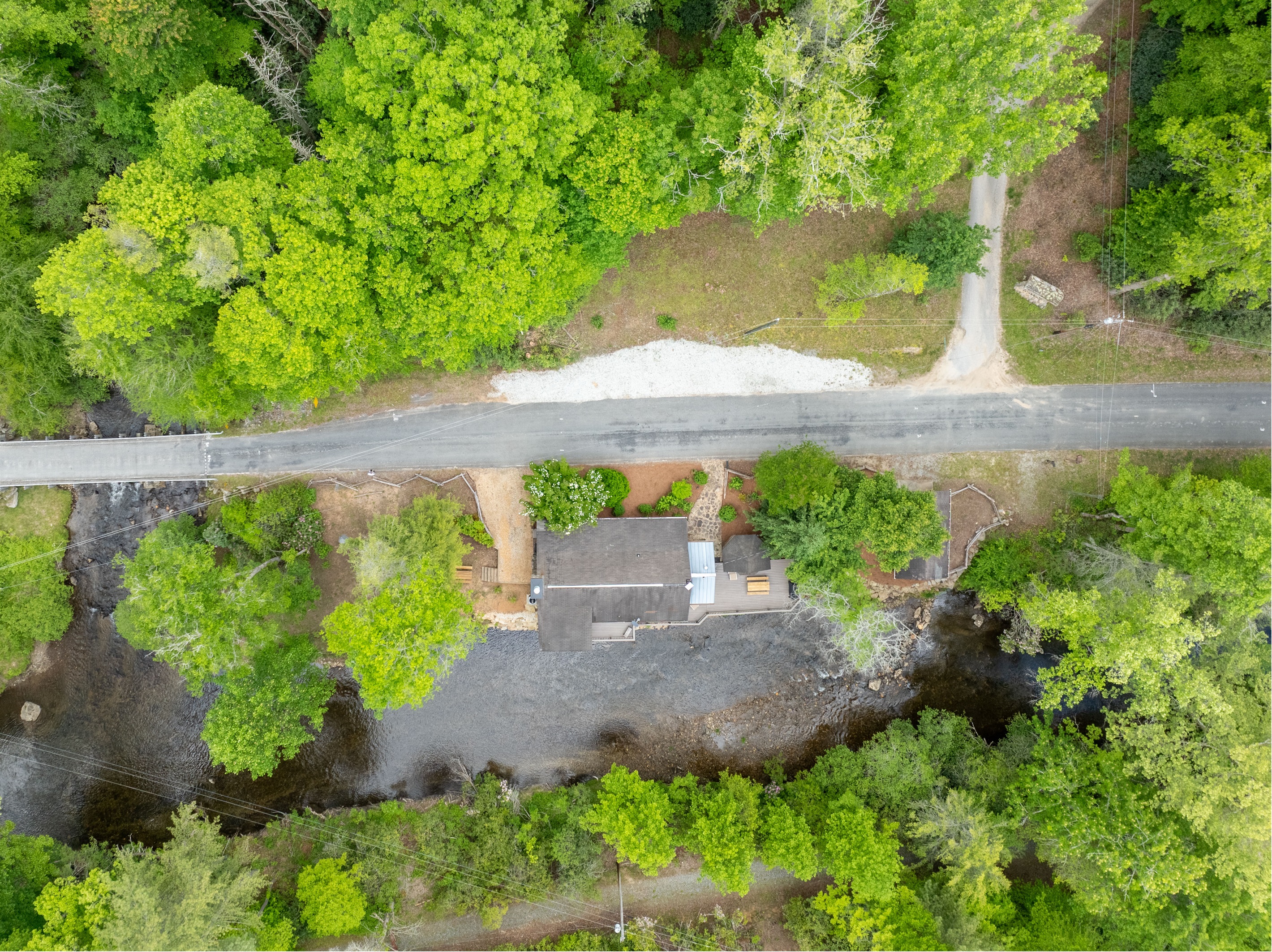 This aerial view showcases the full property, including the scenic junction where Little Snowbird Creek meets Snowbird Creek beside the cabin.