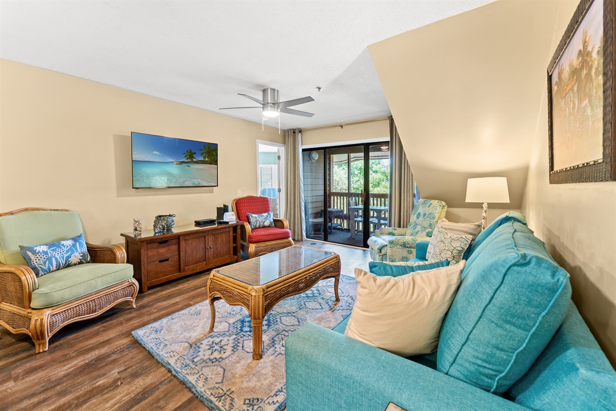 Open concept- large living area with sleeper sofa, large TV and patio access