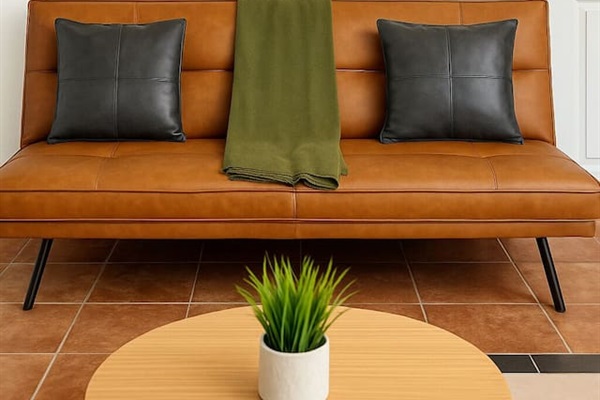 Cozy lounge with leather-style bench, greenery, and mid-century flair — a stylish corner for conversation. 
