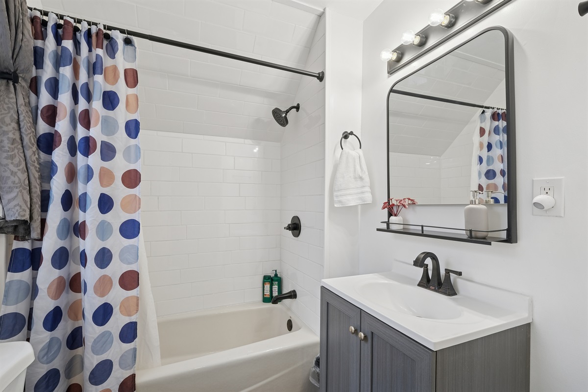 The full bathroom is beautifully remodeled and includes a heat lamp above. 