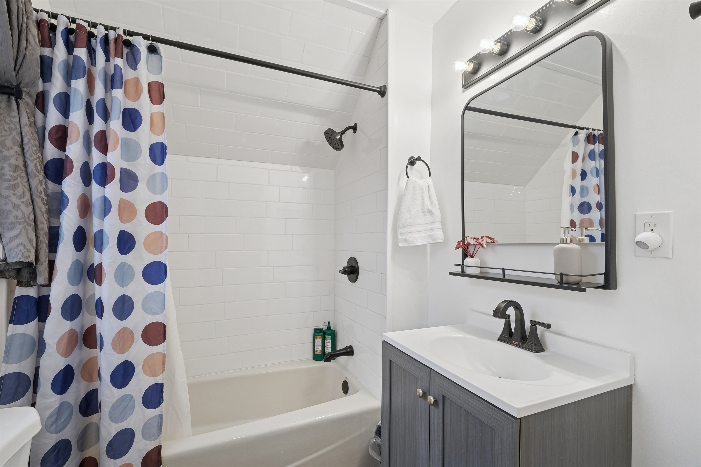The full bathroom is beautifully remodeled and includes a heat lamp above. 