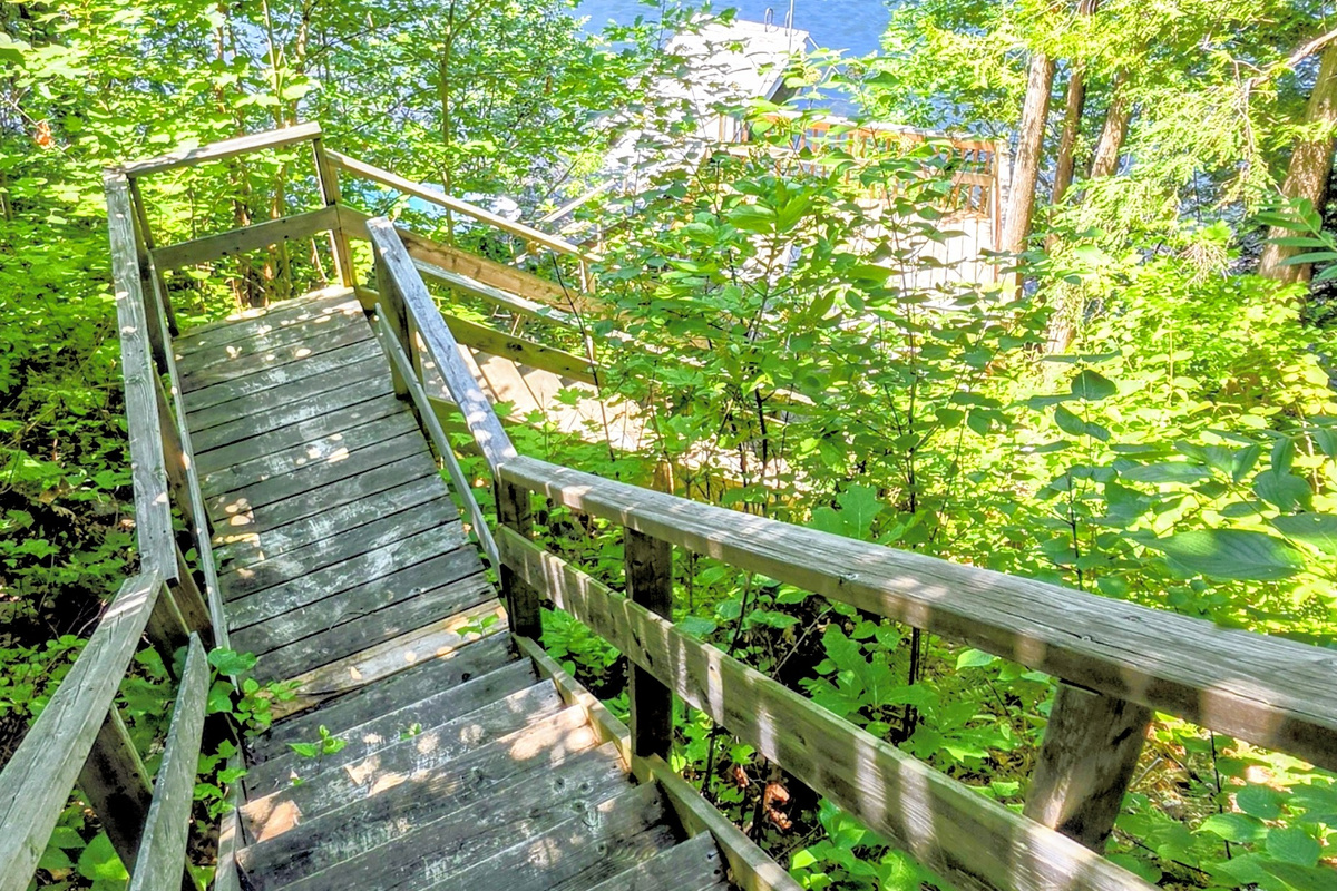 Stairs down hillside to lower deck and dock