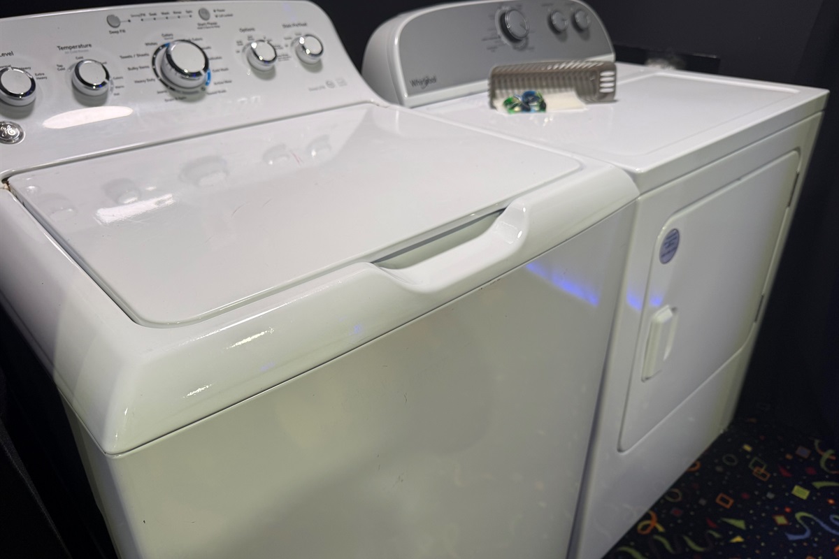 Laundry area with large capacity washer, dryer, detergent pods and dryer sheets 