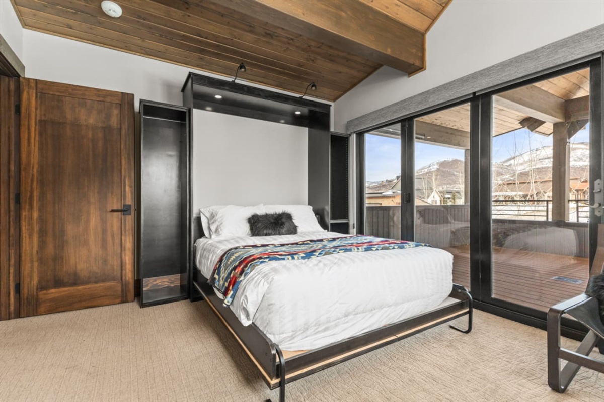 Upper Level Ensuite Bedroom 4 – Currently set up as an office with a Queen Murphy Bed & Private Deck 