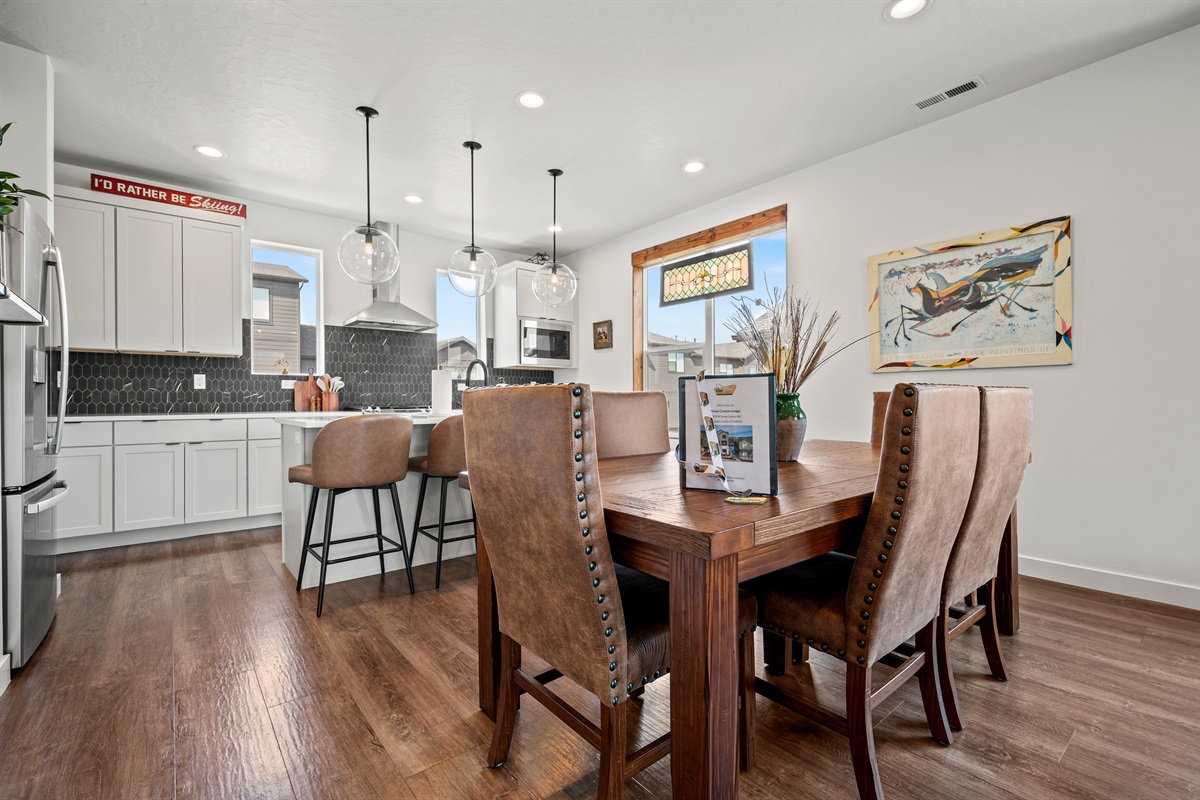 The open-concept kitchen and dining area creates the perfect setting for friendly conversations and shared meals.