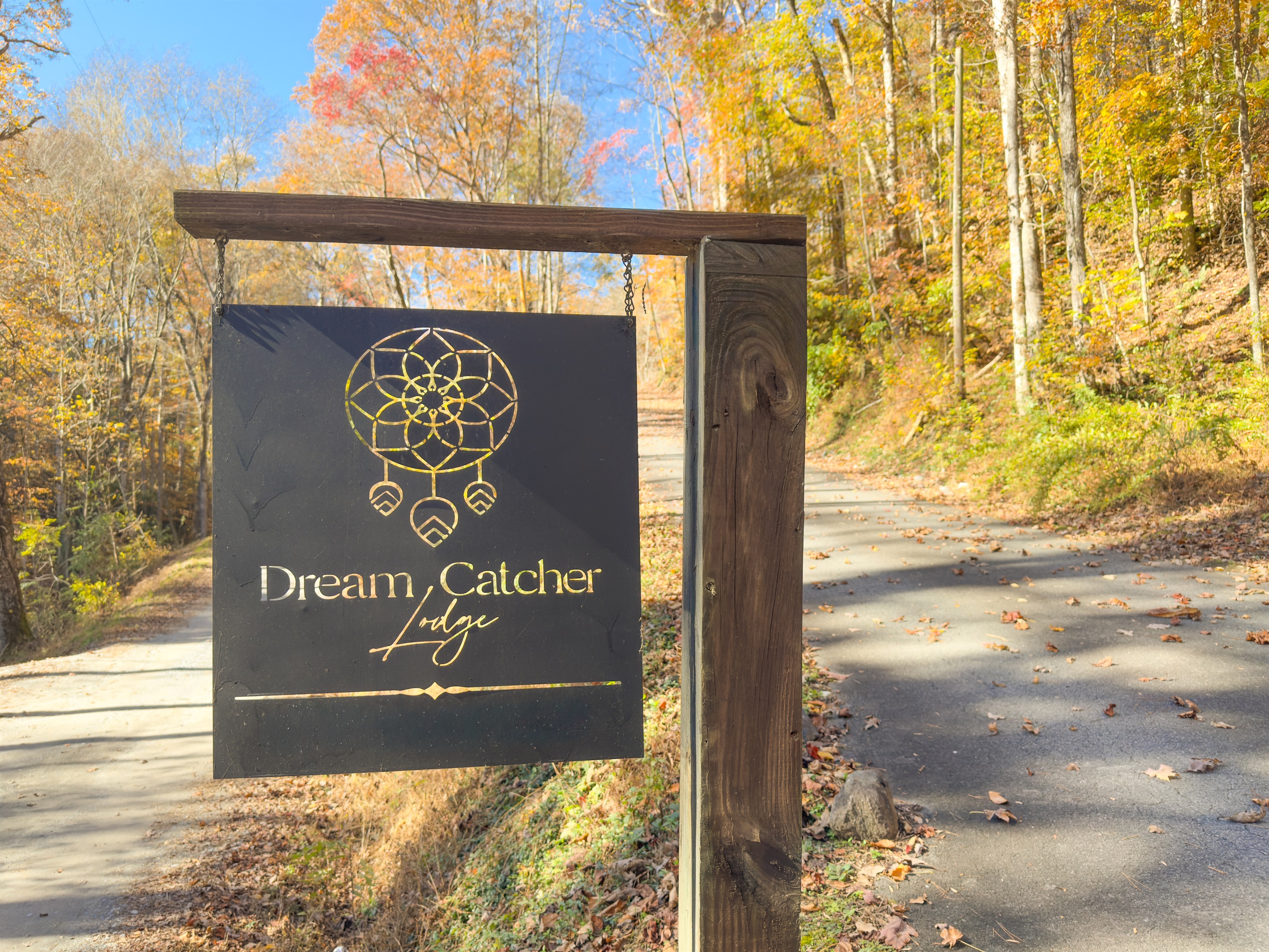 Entrance to the property with a paved road. Small packed gravel section to get to the driveway.