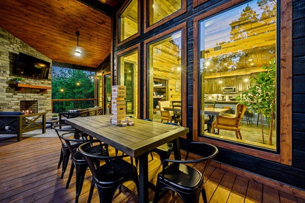 Luxury deck with grill, dining, and stunning forest views.