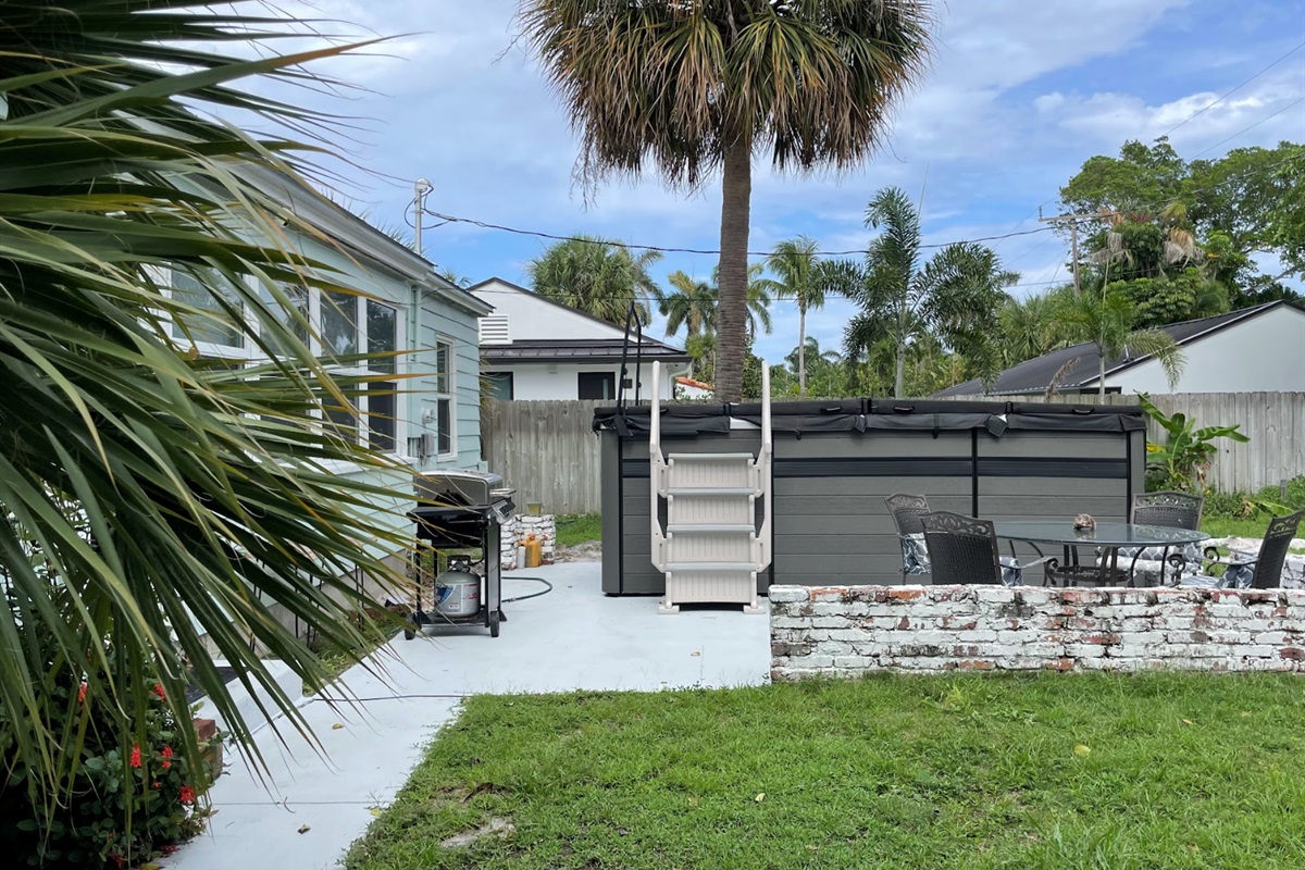 Enjoy the patio as you take in the tropical scenery next to the swim spa.