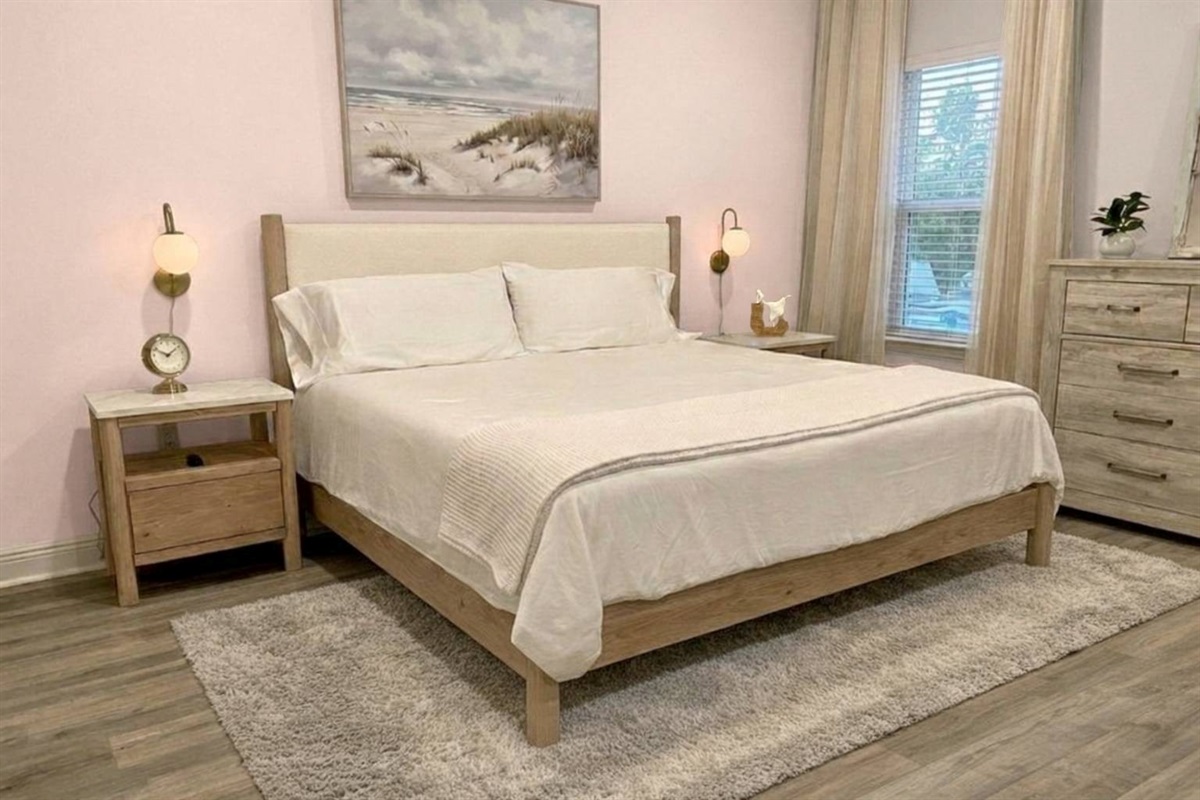 Luxurious primary suite with king bed, walk-in closet, and ensuite bath featuring double vanity.