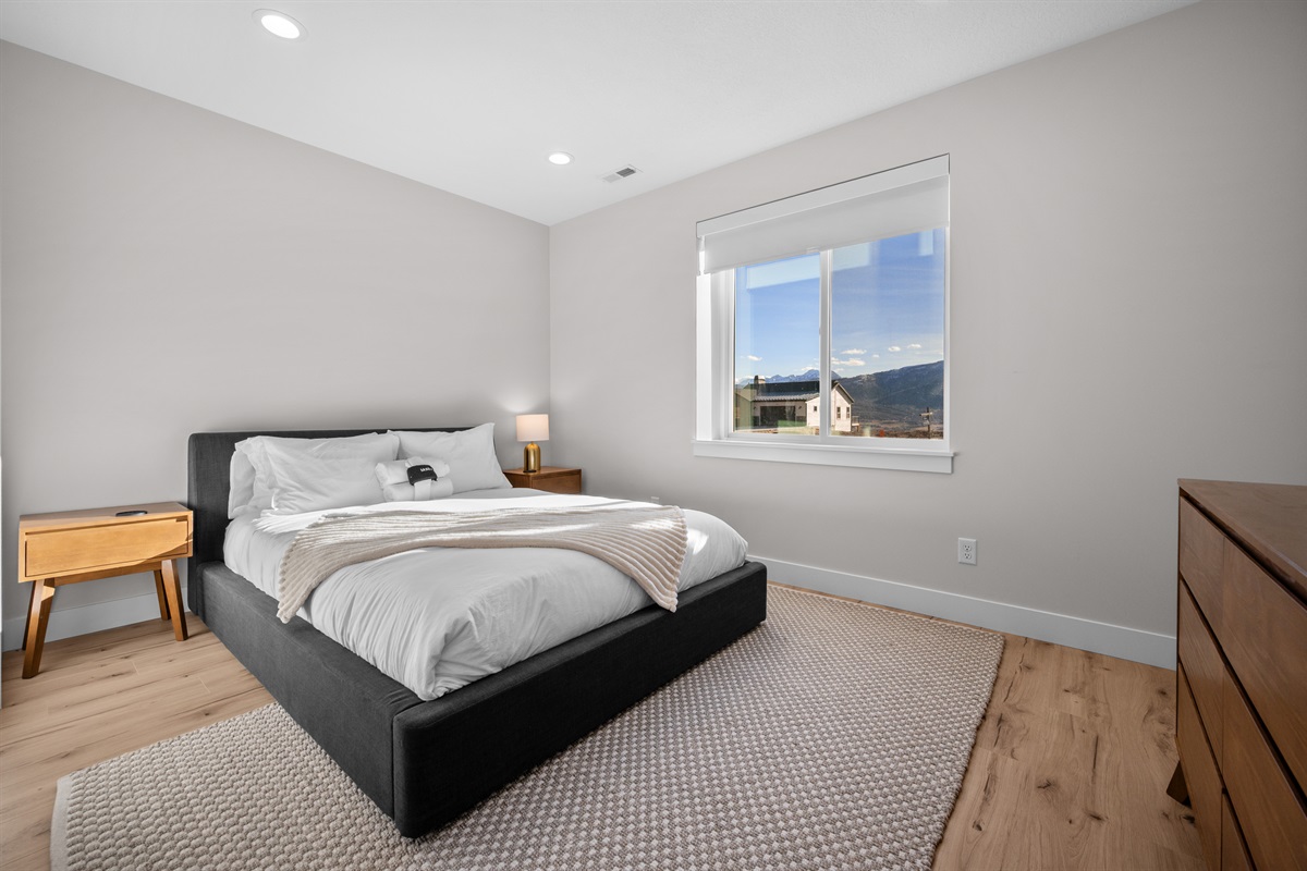 Lower-Level Queen Bedroom with peaceful mountain views.