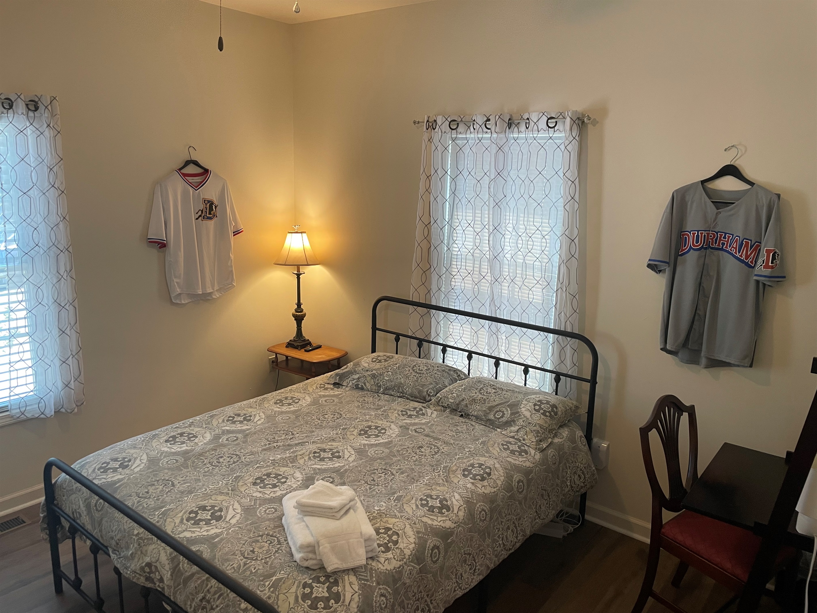 Vintage Durham Bulls Baseball jerseys and memorabilia decorate the Queen sized bedroom