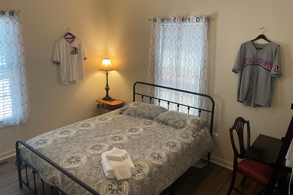 Vintage Durham Bulls Baseball jerseys and memorabilia decorate the Queen sized bedroom