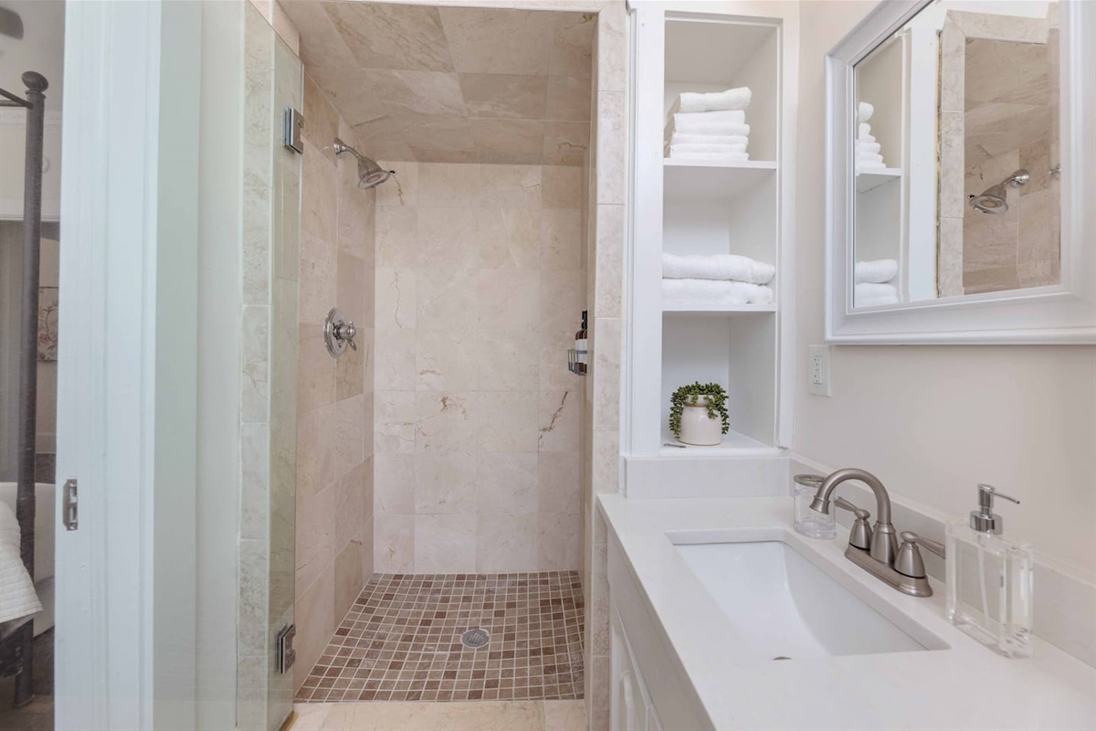 Renovated bathroom with an ADA-accessible shower. 