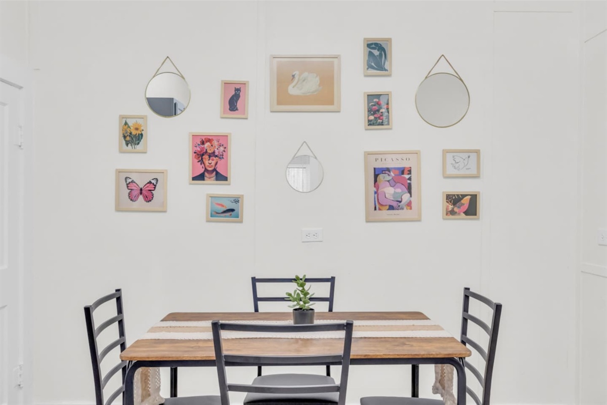 Eat-in kitchen with dining table with seating for 4 and bright natural light.