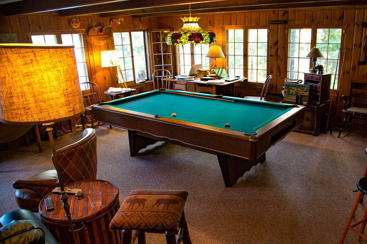 Play pool with friends and family in the living room.