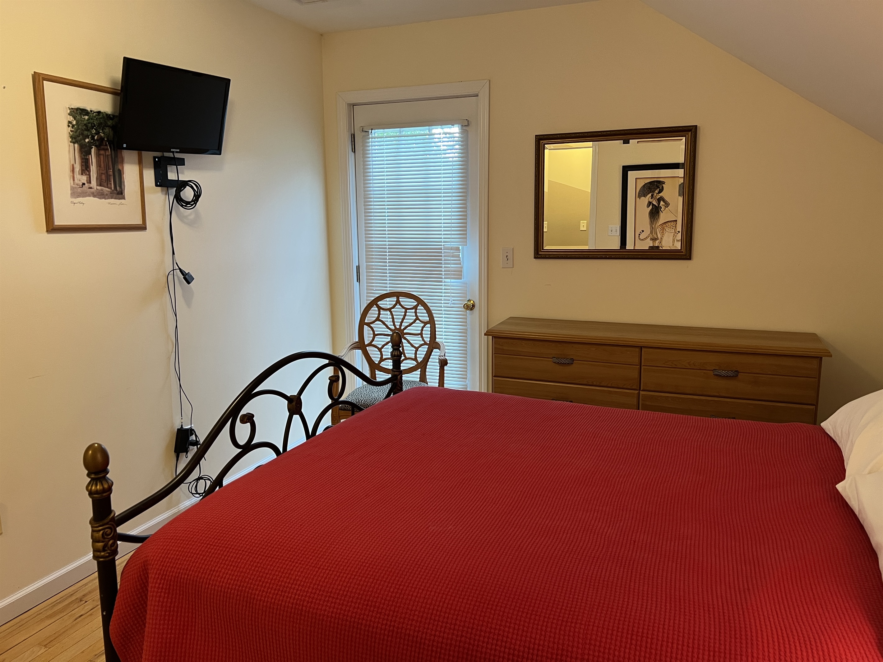 The Federal House Apartment 1, 2nd floor bedroom #2 with smart TV and access to the balcony.