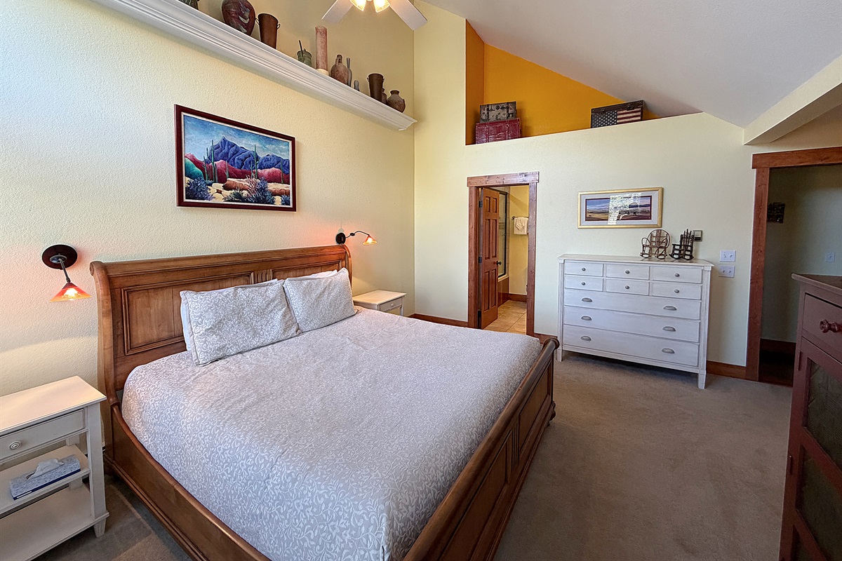 Large primary bedroom with King bed, attached full bathroom and private balcony.