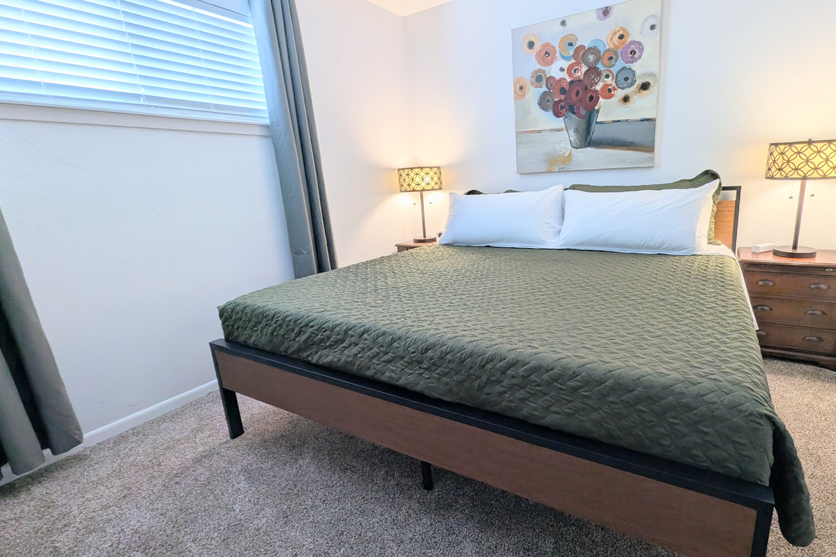 Bedside tables with charging stations add the finishing touch to this comfortable space.
