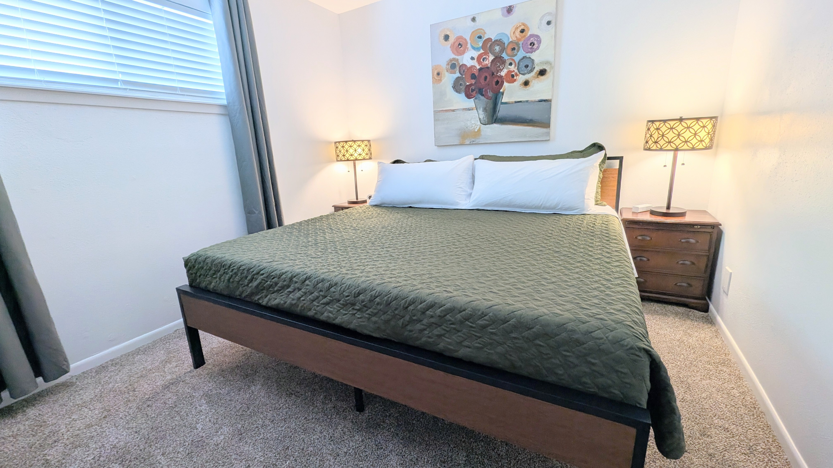 Bedside tables with charging stations add the finishing touch to this comfortable space.
