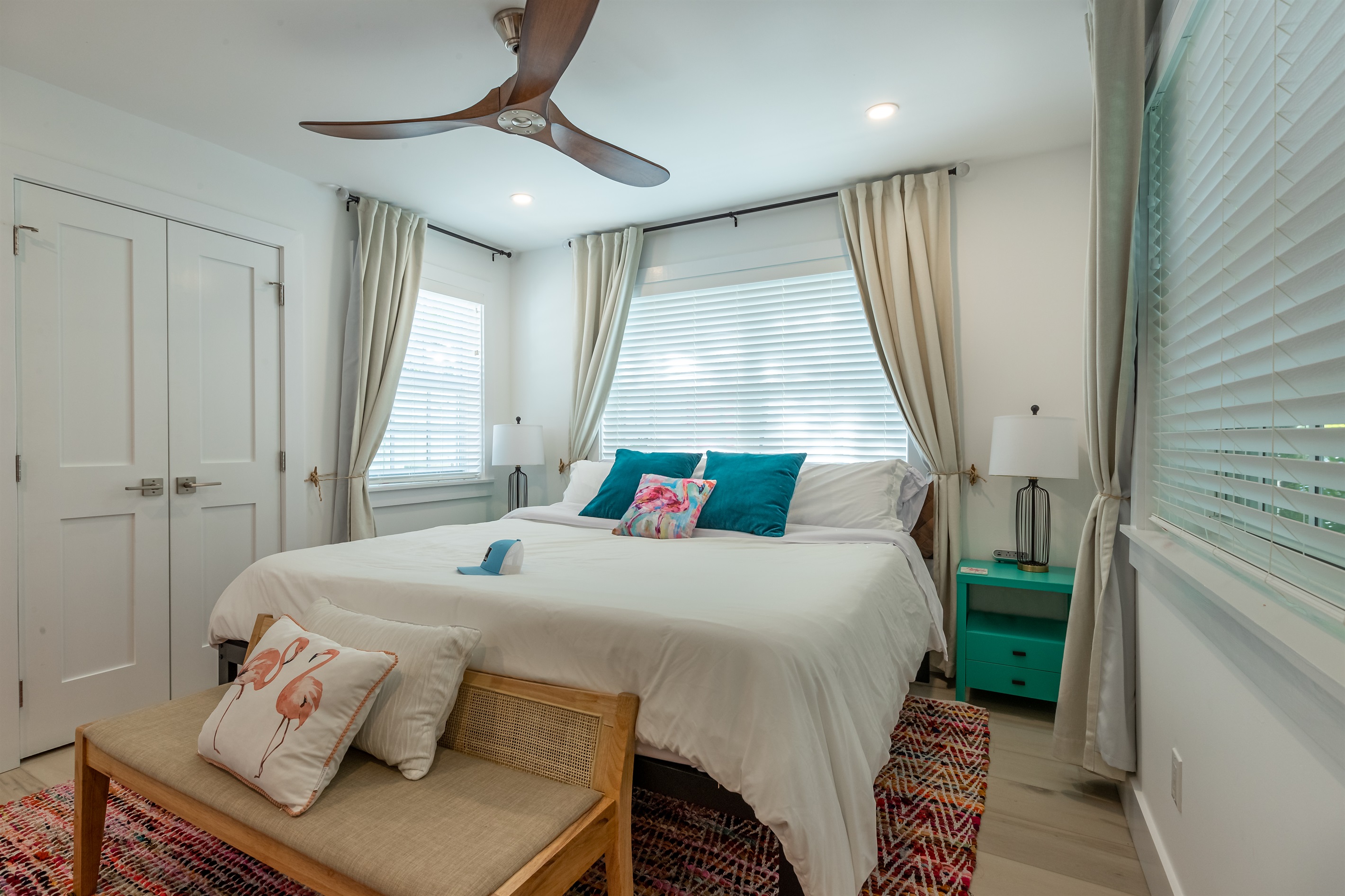Charming Bedroom Retreat: Brightly lit room with vibrant decor and inviting linens for relaxation!