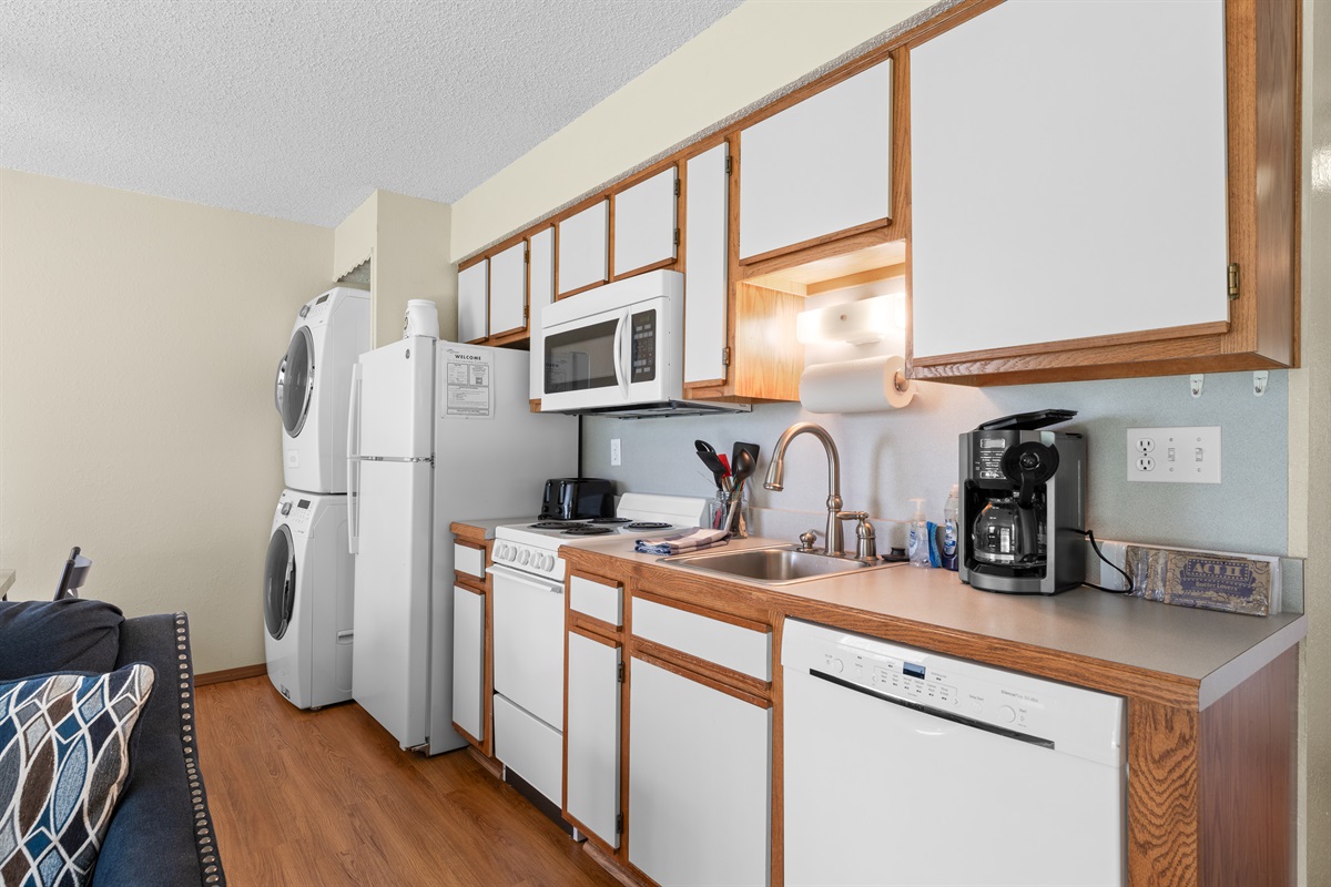 Compact, fully equipped kitchen with all the essentials—plus in-unit laundry.