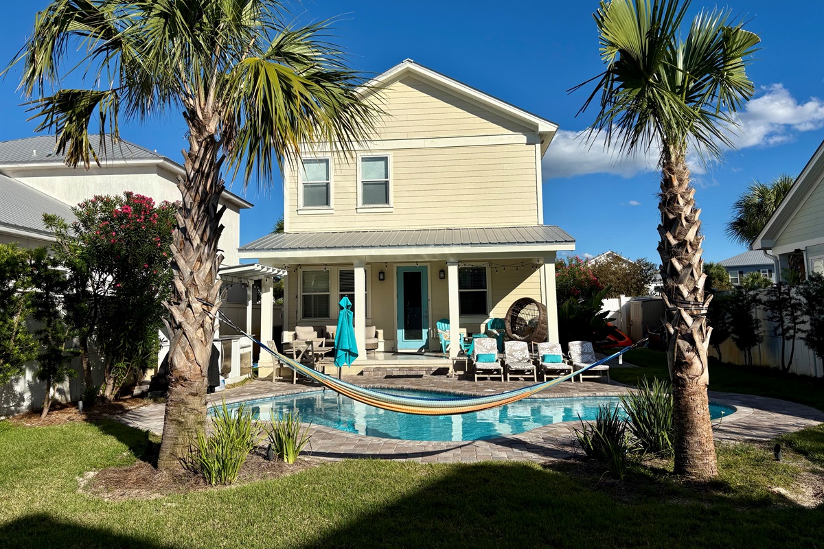 Daytime view of the private backyard with pool and outdoor seating.