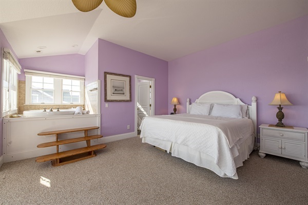Enjoy a luxurious stay at The Hemingway's master bedroom. Equipped with two arm chairs, a dressing table, and an ensuite bathroom complete with a whirlpool, this private retreat is designed to
