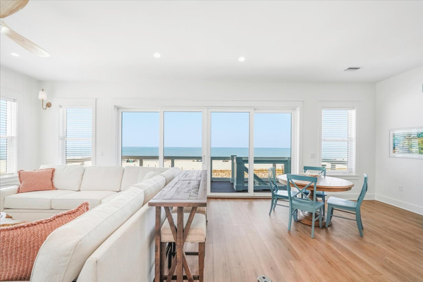 Welcome to the middle floor!  A little more casual with a large sectional, game table, small kitchen, and a balcony with stairs to the pool area.