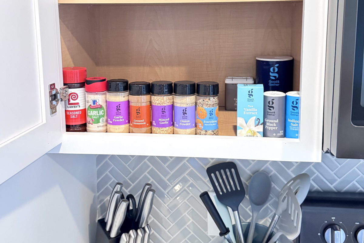 Lots of spices and oils in the cabinet for cooking homemade meals.