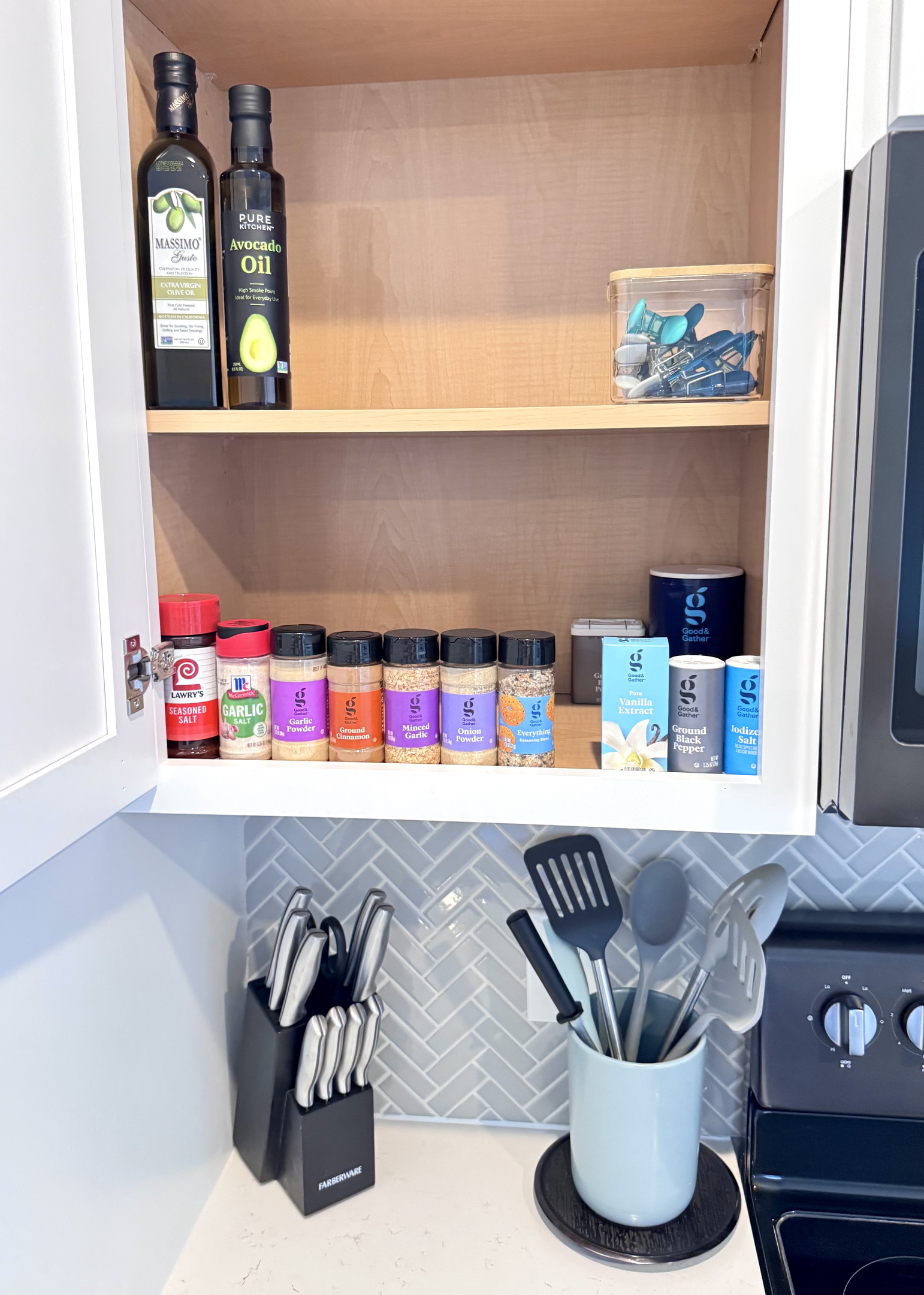 Lots of spices and oils in the cabinet for cooking homemade meals.