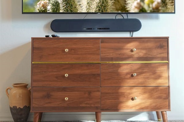 Smart TV mounted above a stylish dresser for relaxing evenings.