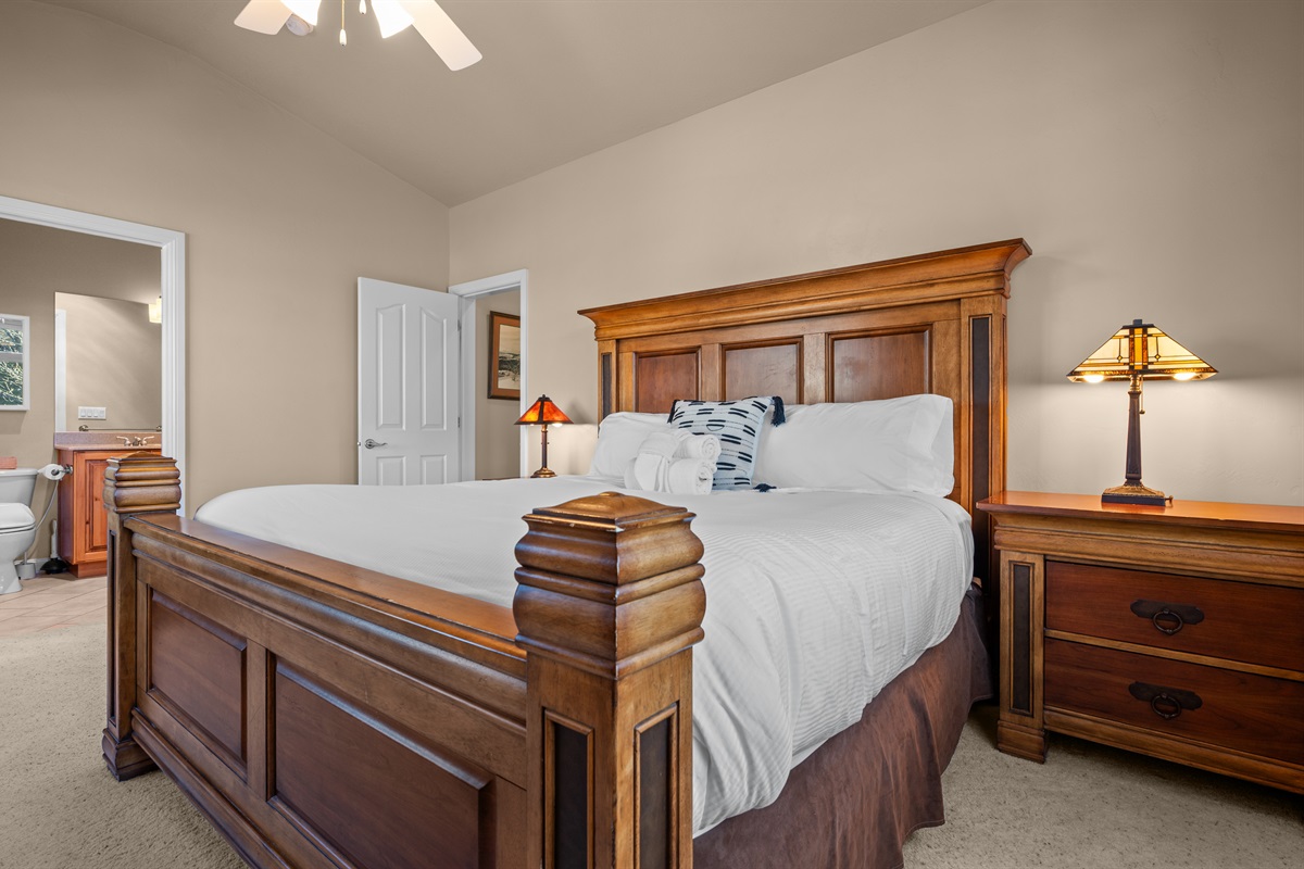 Inviting primary bedroom featuring warm wood furnishings and relaxing resort-style comfort.