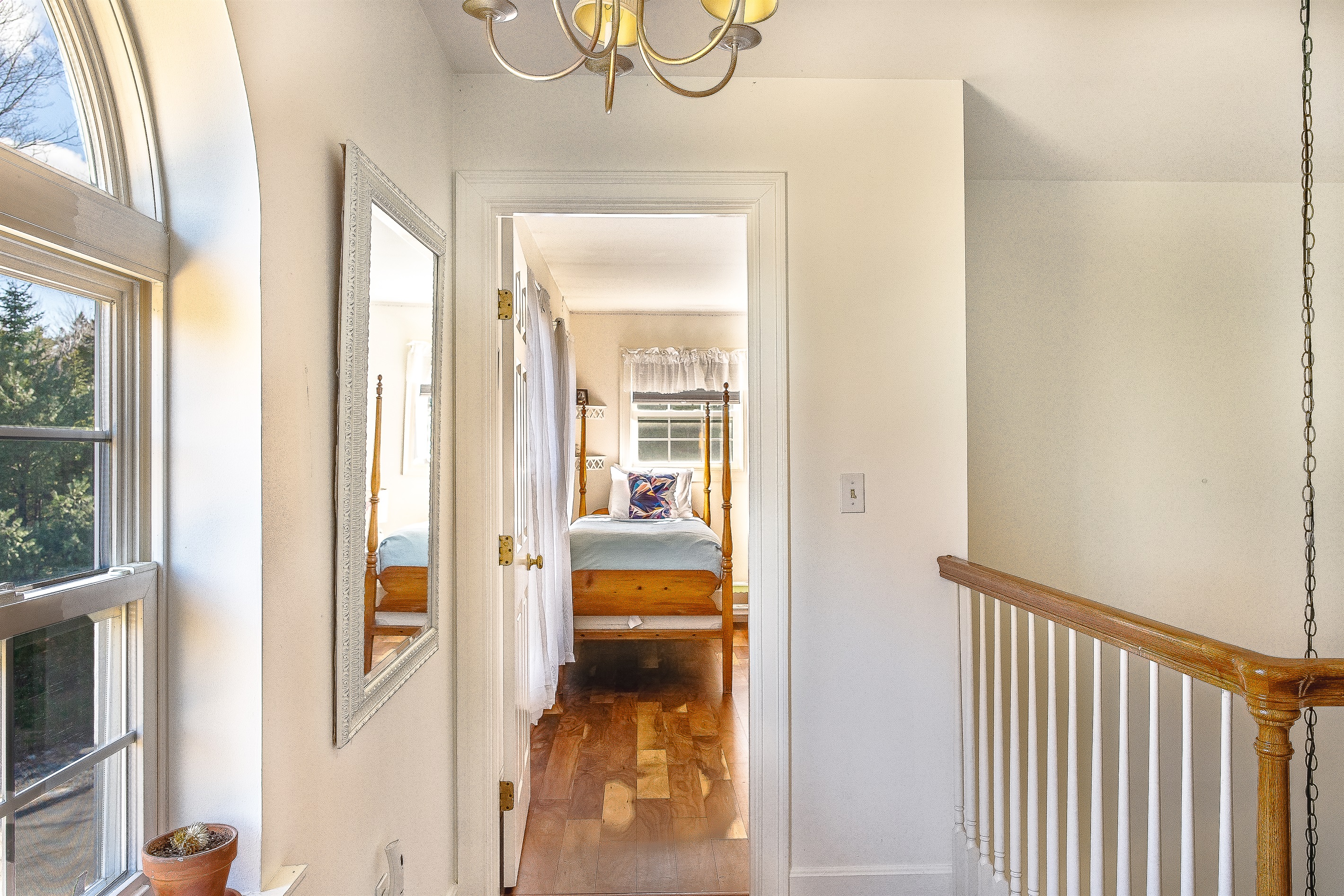 Step into the bright and inviting twin guest room, located just off the sunlit second-floor landing. This versatile space features beautiful hardwood floors and charming four-poster beds, perfect for children or additional guests at Seven Peaks Ridge.