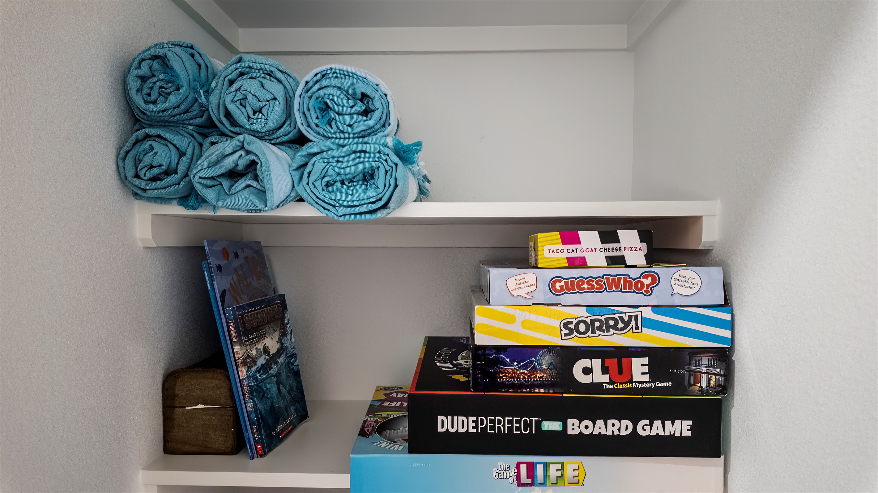 The closet just outside of the Pleasure Pier Guest Suite includes beach towels and games for everyone to enjoy.