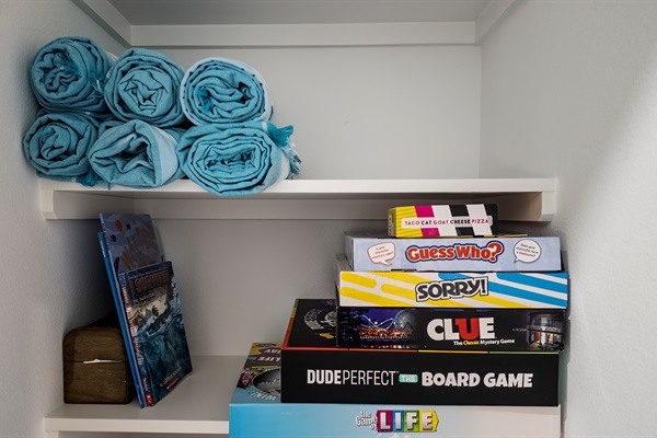 The closet just outside of the Pleasure Pier Guest Suite includes beach towels and games for everyone to enjoy.