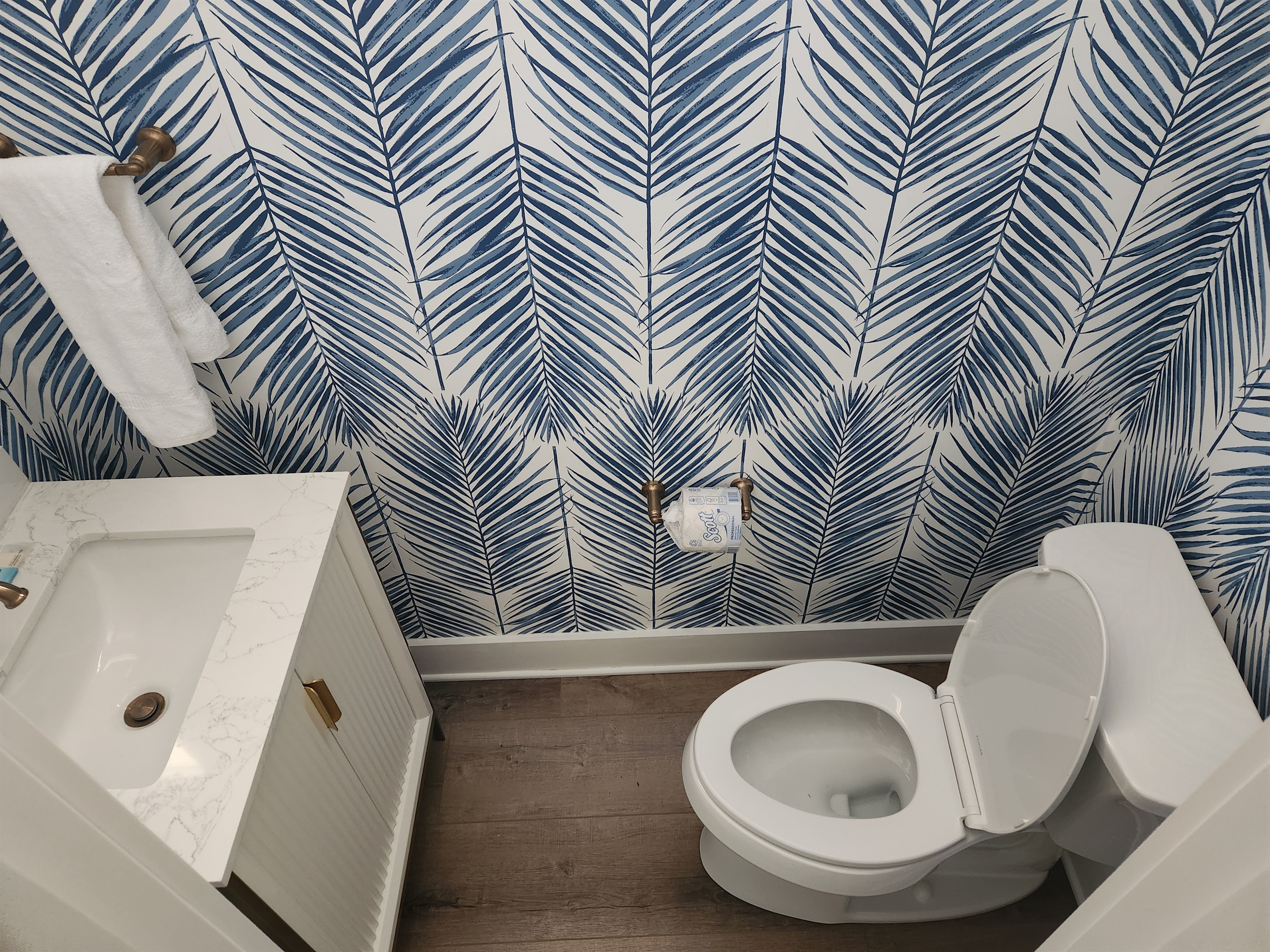 Powder room off hallway to laundry room and carport
