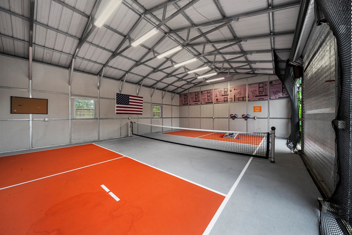 Smack the ball around in the FUN size pickle ball court. The garage is a boredom buster on a rainy day. Corn hole or pickle ball gets everyone up and moving.