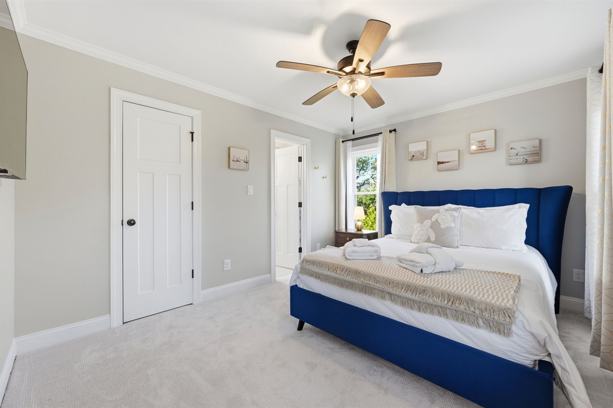Spacious queen bedroom #3 with plush bedding, Smart TV, and calming coastal-inspired d&eacute;cor