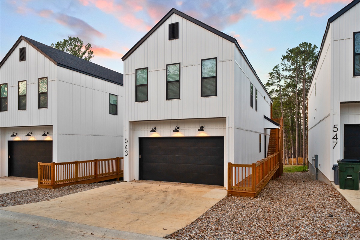 A clean, modern exterior with easy driveway access and a quiet lakeside setting.