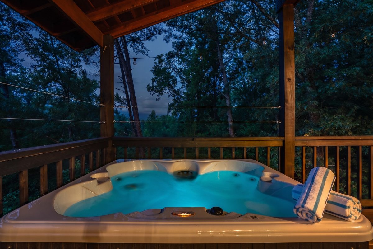Relax and recharge in the upper deck hot tub as twilight settles over the Smoky Mountains—the perfect way to unwind after a day of hiking and exploring.