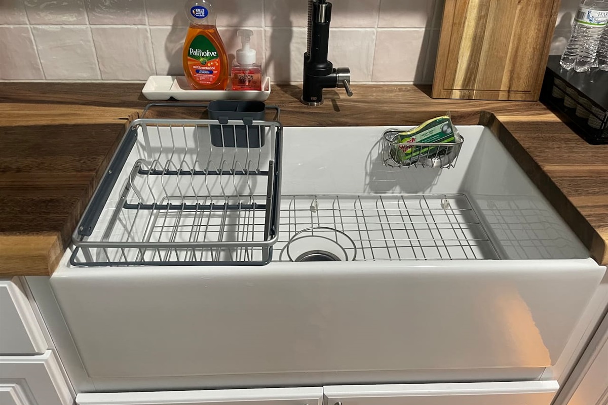 Oversized apron front sink with drying racks make clean up easy. 