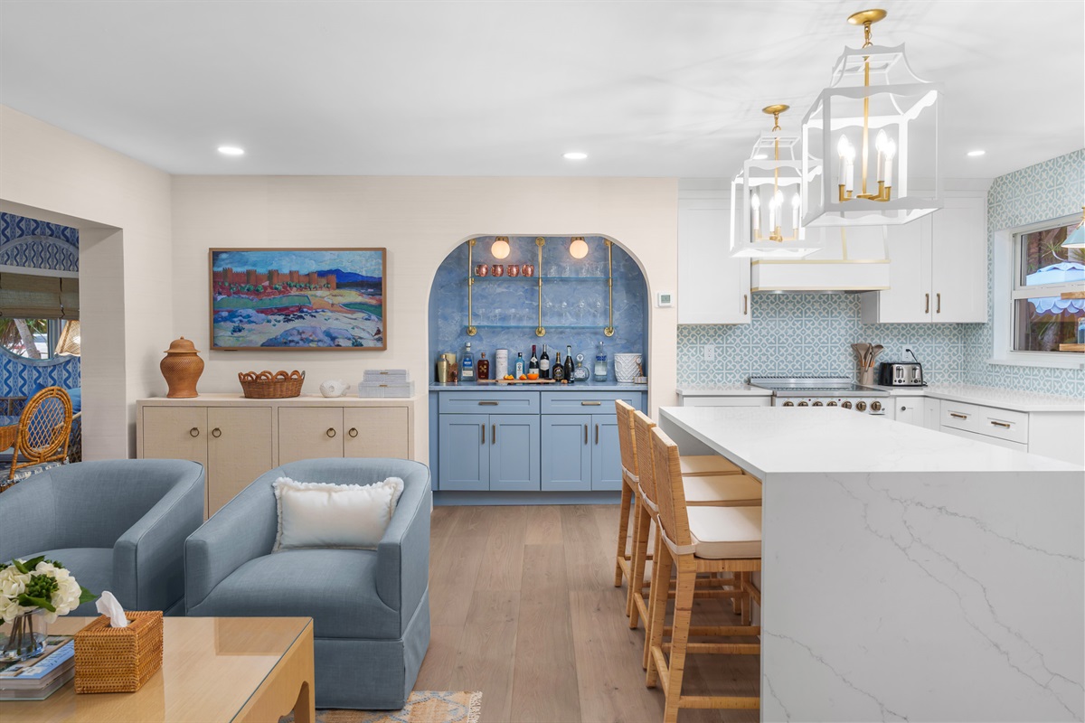 Gather in style in this open-concept space featuring a designer kitchen, oversized island, and a dedicated beverage station for easy entertaining.
