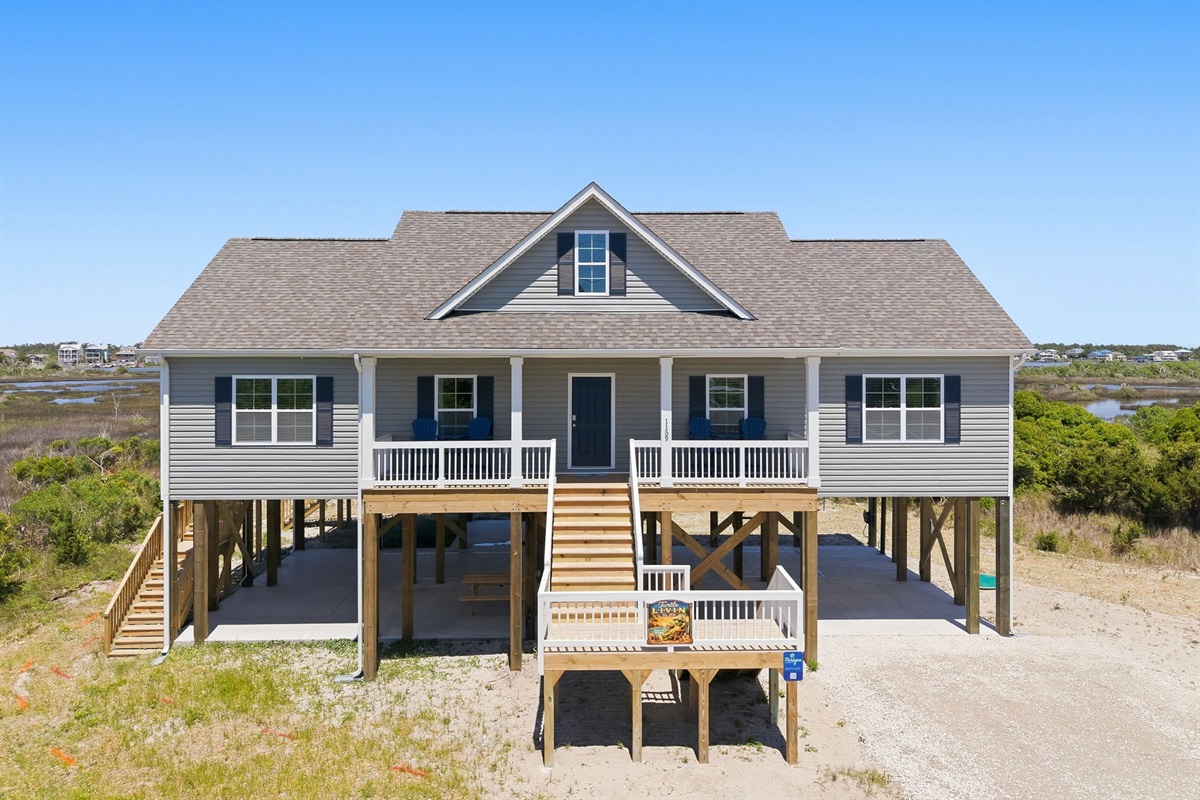 An elevated coastal home with spacious covered parking & outdoor hangout area