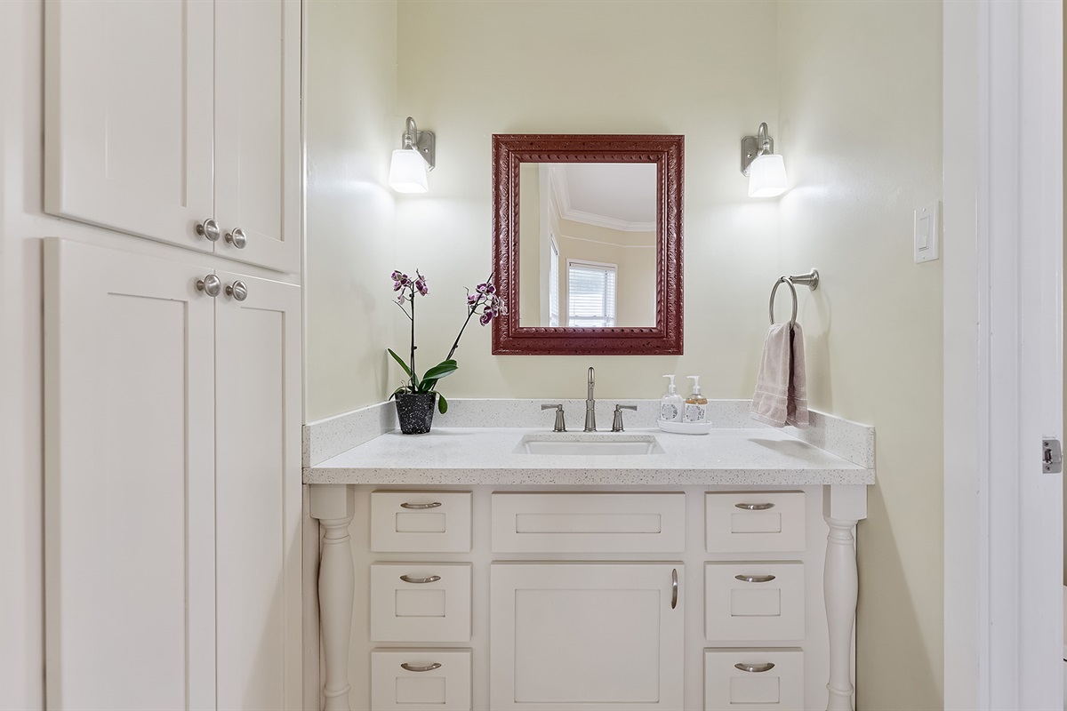 Full Bathroom #2: Single sink with marble counter top located at each end.