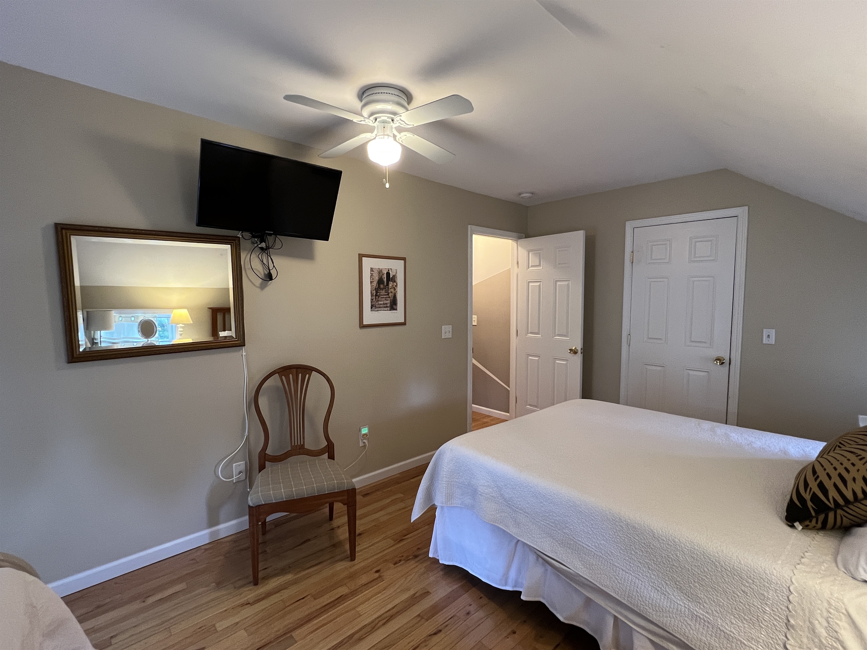 The Federal House Apartment 1, 2nd floor bedroom #1 with balcony access and a smart TV.