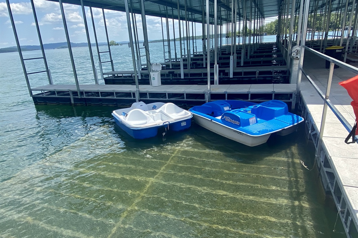 Kayaks and paddle boats available for checkout at the dock