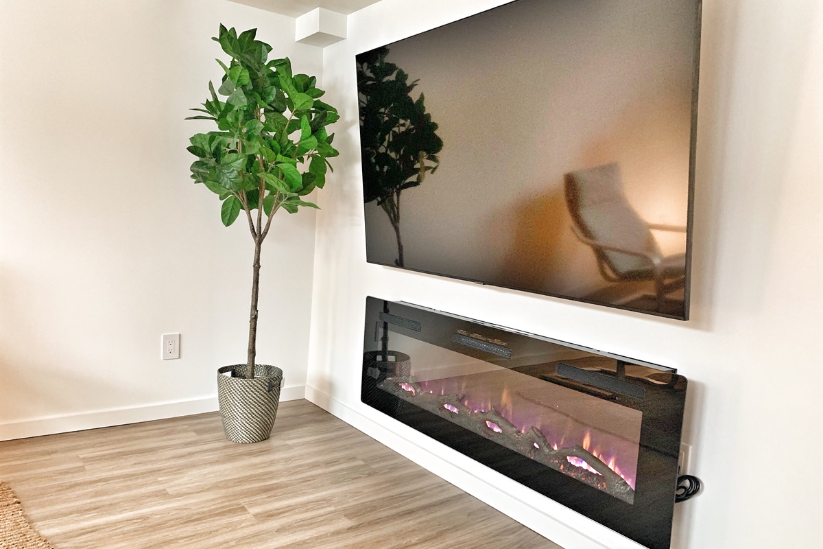 Living area with fireplace and Smart TV for streaming your favourite shows.